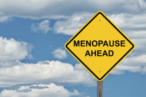 A yellow sign reads, "Menopause Ahead."