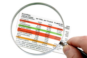 A magnifying glass hovers over a nutrition label.