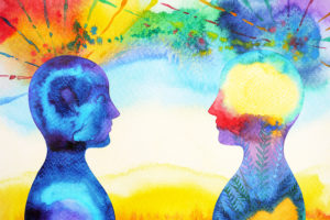 An illustration of two humans are shown looking at each other.