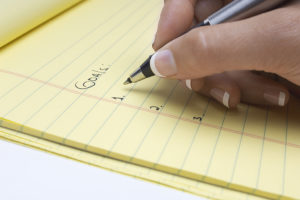 A person writes down their SMART goals.