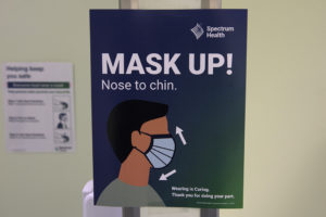 A Spectrum Health sign reads: "Mask up! Nose to chin."