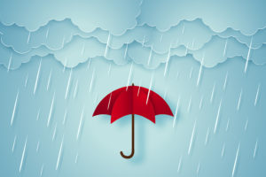 A red umbrella is shown under rain clouds.